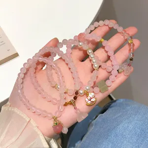 Sweet pink crystal beaded bracelet set for women, cute peach and lotus charms, sweet style.
