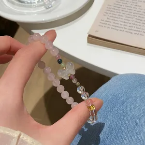 Charming pink crystal bracelet with a cute butterfly charm, delicate beaded design for daily wear.