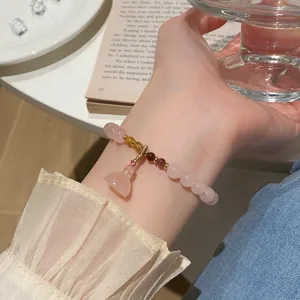 Close-up of the delicate pink crystal lotus pendant bracelet detail shot lifestyle aesthetic