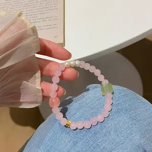 Detailed view of the sweet pink crystal beaded bracelet with pearls and green stone.