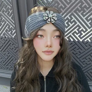 Grey knit headband with sparkling rhinestone crystal flower detail, cozy winter hair accessory.