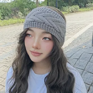 Close-up view of the grey knitted winter headband, cozy cable knit warm hair accessory.