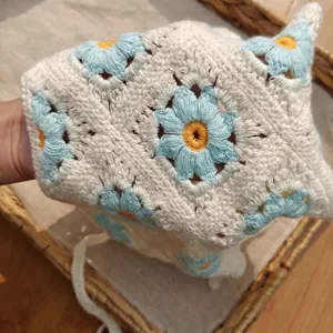 Crochet daisy headscarf detail view, knitted floral hair accessory for pastoral sweet styles.