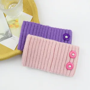 Cozy knitted ear warmer headband featuring pearl buttons, stylish ribbed winter hair band.
