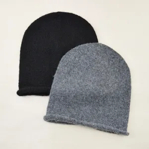 Detail view of the soft knitted rolled edge beanie, showing fine knit texture and stitching.