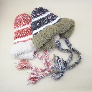 Cozy plush knit beanie with braided tassels, warm earflap pullover winter hat for women.