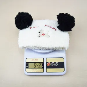 Fluffy coral fleece headband with cute animal embroidery and black pom pom for washing.