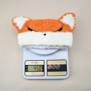 Close-up of cute fox ear embroidery coral fleece headband detail, soft texture and comfortable fit.
