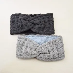 Detailed view of the thick knitted twist headband showing textured wool and soft warm plush lining.