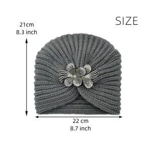 Details of the grey knitted pullover hat with a sparkling rhinestone flower brooch, warm winter cap.