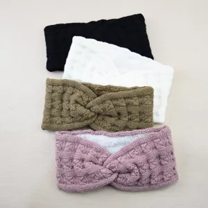 Detailed view of the thick fleece-lined knitted twist headband, soft wool ear warmer texture.