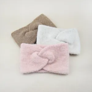 Detail shot of cozy imitation wool wide knitted headbands, warm cross hair bands for winter.