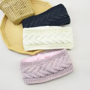 Detailed view of the plush-lined cable knit headband, soft texture for cozy winter warmth.
