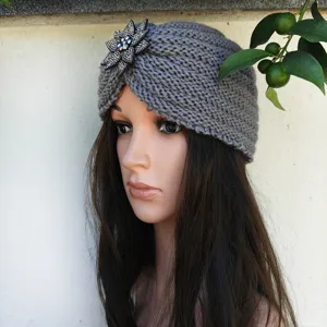 Grey knitted turban hat detail featuring a sparkling rhinestone flower brooch for women winter.