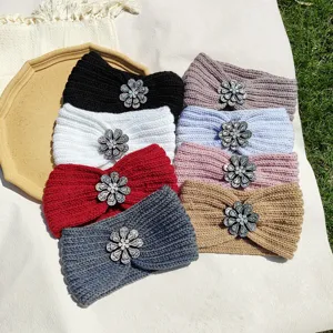 Close up view of colorful knitted headbands with sparkly rhinestone flower accessories.