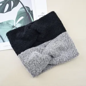 Close-up detail shot of fuzzy twist knitted headbands in black and gray, soft plush texture.