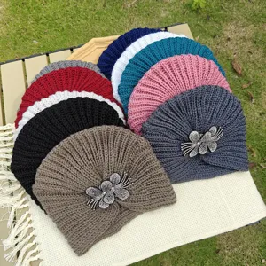 Detailed view of women's knitted rhinestone flower beanie hat, winter warm head wrap caps.