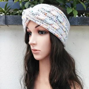 Detailed view of the cozy knitted twist headband with colorful speckles and warm winter lining.