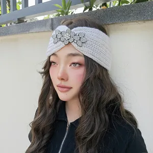 Chic knitted winter headband featuring sparkling crystal floral rhinestones, cozy detail view.