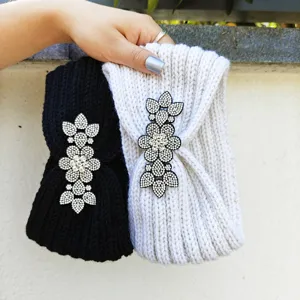 Detailed close-up of thick knit rhinestone flower headbands, winter warm cozy hair accessories.