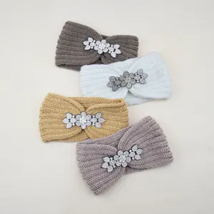 Close-up of crystal flower rhinestone knitted headband detail showing premium woolen texture.