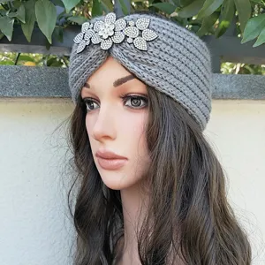 Grey knit winter headband with sparkling rhinestone flower decoration, warm and stylish hair accessory.