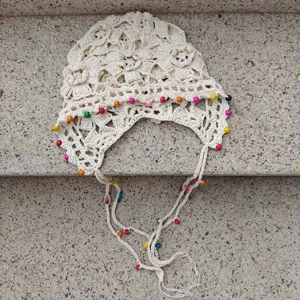 Handmade crochet knit bonnet with colorful wooden beads, hollow flower tassel beanie hat.