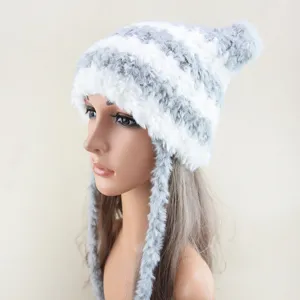 Detailed view of the fluffy striped winter hat for women, featuring warm earflaps and pom-pom.