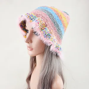 Vista dettagliata del cappello arcobaleno lavorato a maglia con bordo in morbido peluche.