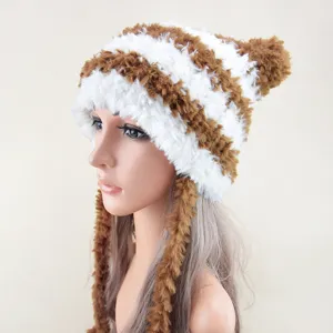 Fluffy brown and white striped winter warm hat with cute earflaps and pom pom detail shot.