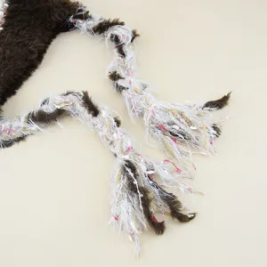 Detail shot of colorful knitted hat's braided tassel strap, warm wool texture for women winter.