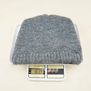 Grey solid color wool knit beanie hat, cozy and warm winter headwear detail display.