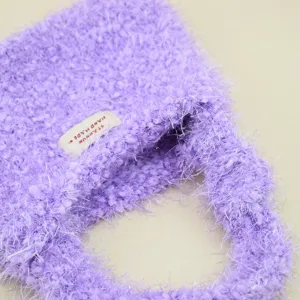 Borsa a mano in maglia soffice viola dettaglio primo piano texture morbida moda invernale