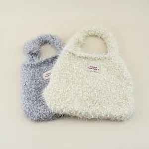 Vista dettagliata della borsa a mano in maglia di peluche carina, materiale di lana morbida, stile.