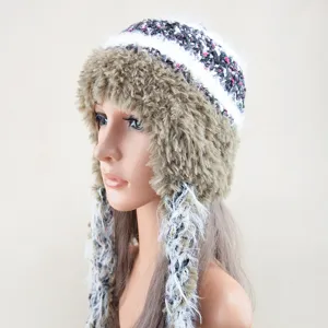 Winter warm knit trapper hat with fluffy plush trim and cute side tassels for women.