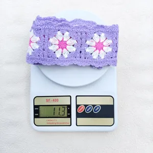 Detailed shot of purple crochet floral headband, featuring cute daisy granny squares for a sweet look.