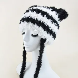 Close-up view of the black and white furry striped warm hat detail with long plush earflaps.