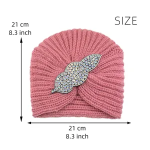 Pink knit turban hat with dazzling rhinestone leaf accessory, warm winter beanie for women.