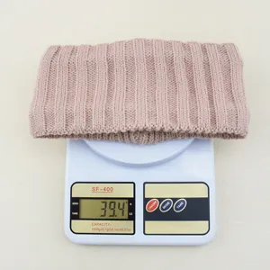 Knit headband detail view showing weight, thick ribbed winter warm hair accessory.