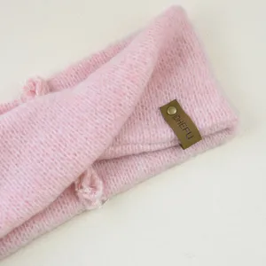 Pink mohair knit headband, cozy winter ear warmer and stylish cross hair accessory.