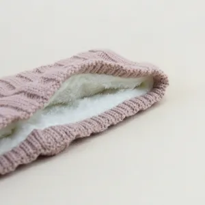 Detailed view of the pink cable knit fleece-lined headband, showing the plush warm inner lining.