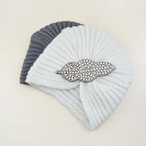 Cozy winter knitted turban hat featuring sparkling rhinestone leaf detail, warm retro ethnic style.