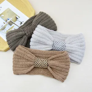 Knitted headband detail showing the soft ribbed texture and sparkling sequin bow design.