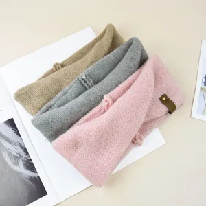 Knit mohair cross headband detailed view, showing soft texture and cozy winter accessories.