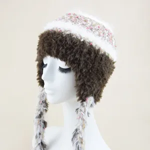 Detailed view of a cozy winter knit hat with colorful tweed pattern, plush earflaps and braids.