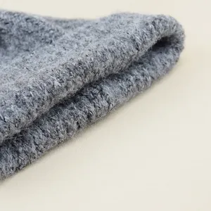 Grey imitation wool knitted hat detail, soft winter warm beanie texture close-up display.