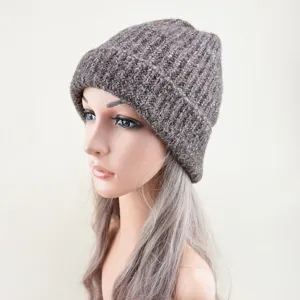 Detailed view of the warm knitted beanie hat texture, featuring a rolled brim design.