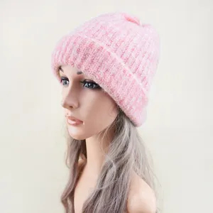 Pink knit beanie close up view showing soft cuffed texture and warm fabric detail