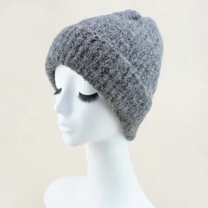 Detail view of grey knitted beanie, warm winter cuffed hat shown on mannequin head.