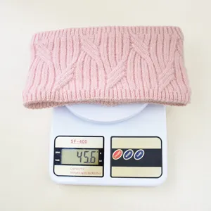 Pink knitted headband detail view, soft woolly ear warmer texture with subtle silver threads.